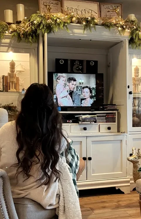 Family watching a television together in a comfortable living room
