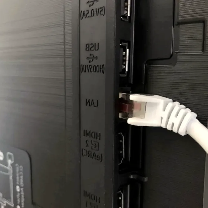 Close-up of television HDMI ports and connected cables